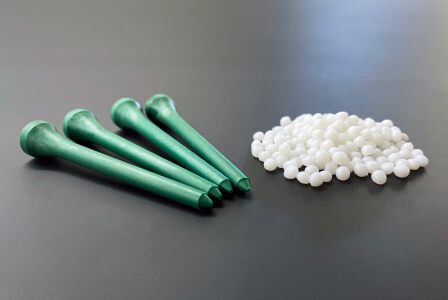 Verde's bioresin pellets next to golf tees made from bioresin